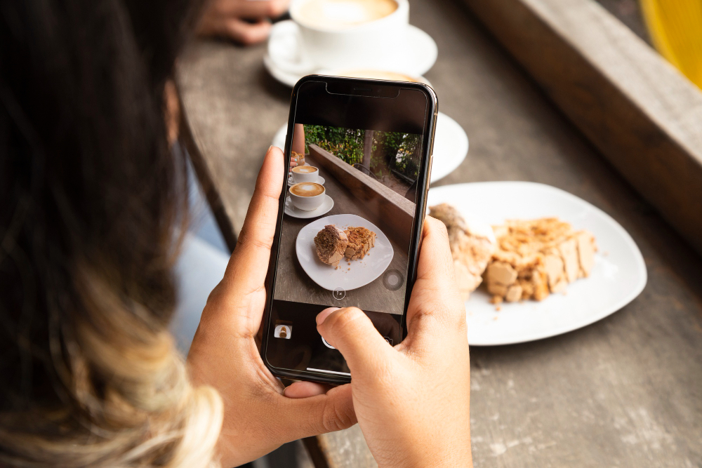 woman taking photo of food